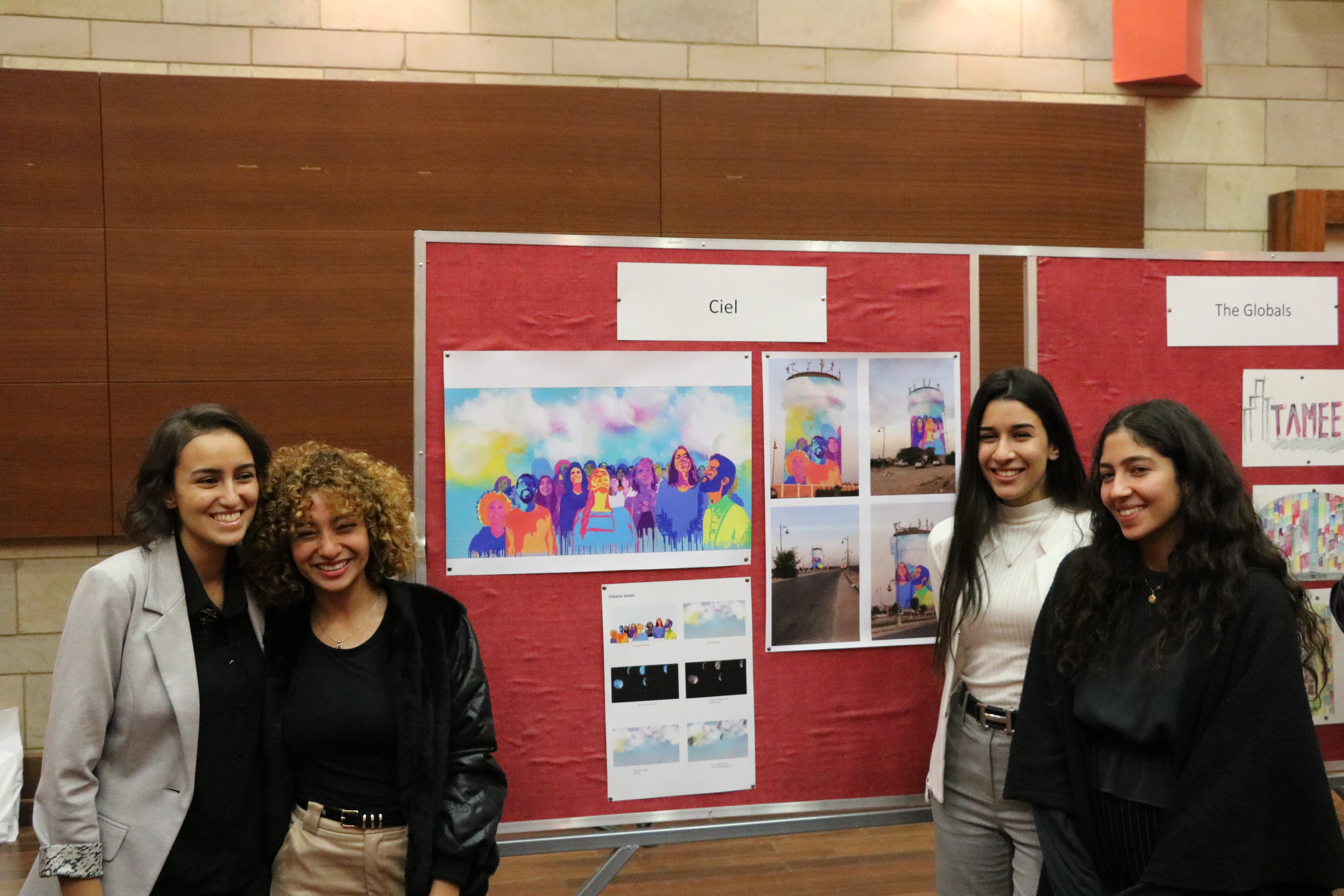Four girls standing by their project 