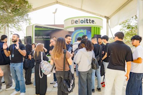 a group of students standing at a booth during employment fair
